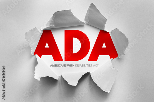 ADA acronym in bold letters revealed through torn paper, representing the Americans with Disabilities Act. Symbolic image for accessibility, disability rights, equality, and inclusion