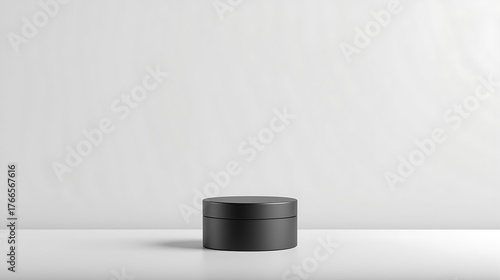 Minimalist Beauty Jar: A sleek black jar sits elegantly on a clean, light surface, exuding a sense of modern simplicity. The focus is on the product's understated design.