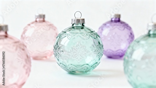 Delicate pastel-colored glass Christmas ornaments arranged on a white surface, perfect for holiday decor and festive inspiration.
