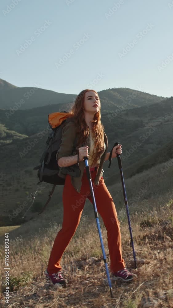 custom made wallpaper toronto digitalred haired woman hiking alone in autumn mountains with backpack and trekking poles vertical slow motion video symbolizing freedom mindfulness adventure lifestyle and solo travel spirit