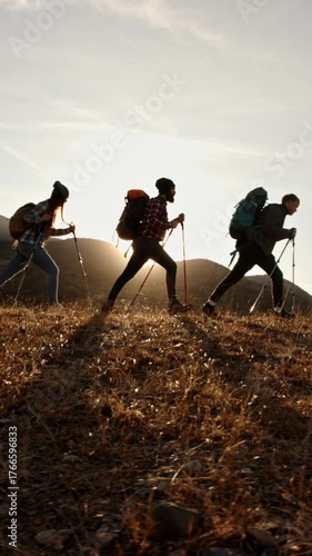 group of young hikers walking uphill in glowing sunset light vertical slow motion video symbolizing adventure spirit freedom teamwork mindfulness travel lifestyle and connection with nature