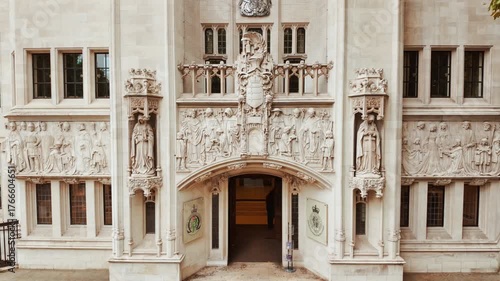 The Supreme Court in London, England, UK, showing carved stone, arched windows and civic emblems by Parliament Square