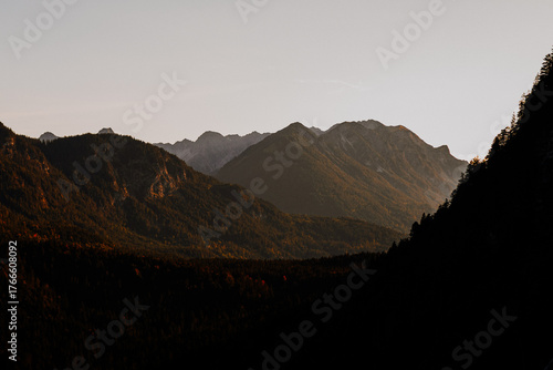 Moody silhouette of alpine mountain layers in Tyrol at dusk, Austria