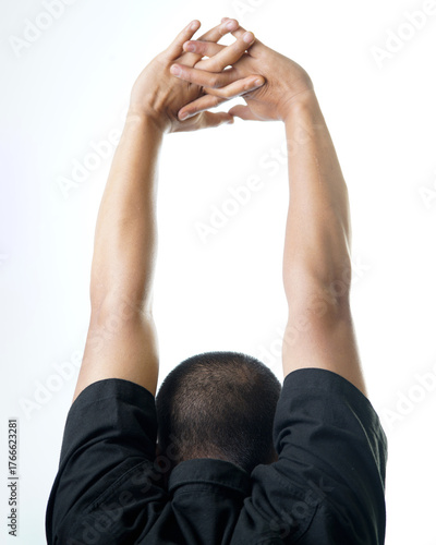 Man stretching arms overhead, feeling refreshed and energized after workout or yoga session, promoting wellness and healthy lifestyle