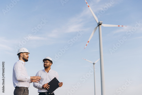 Engineers discussing about a wind turbine project
