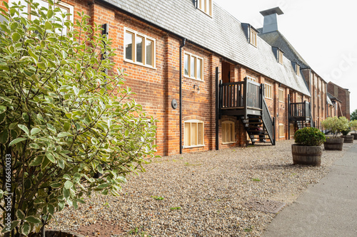 A former malting facility in Suffolk, UK now turned into private apartments. Part of the old malting roof can be seen in the distance.