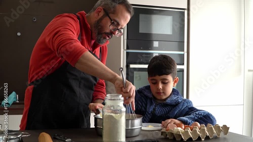 Father and son cooking together at home kitchen