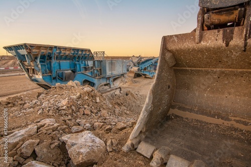 Heavy and mobile machinery in a quarry to transform stone into construction material