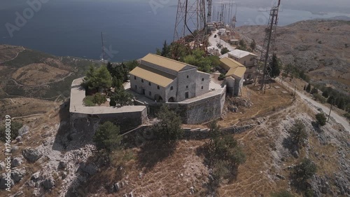 Summer drone video of seaside village in Greece. Church, Monastery