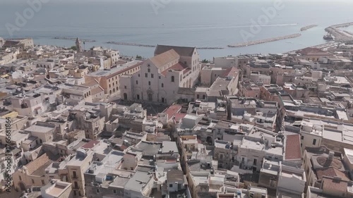 Aerial view of Greek coastal town with church by the sea