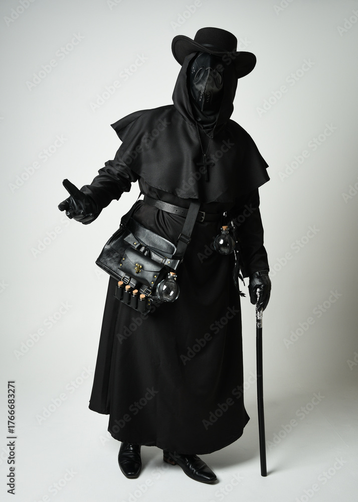 Fototapeta premium Plague Doctor Full length walking Silhouette Portrait of Gothic Halloween Character with Beak Mask, Black Cloak on White Studio Background, Dramatic Dark Costume and Fantasy Horror figure