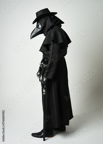 Plague Doctor Walking Away, Full length Silhouette Portrait of Gothic Halloween Character with Beak Mask, Black Cloak, Walking Stick on White Studio Background, Dramatic Dark Costume and Fantasy Horro