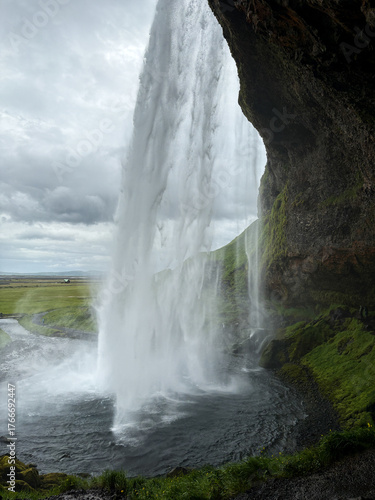 View from behind Seljalandsfoss in Iceland in summer.