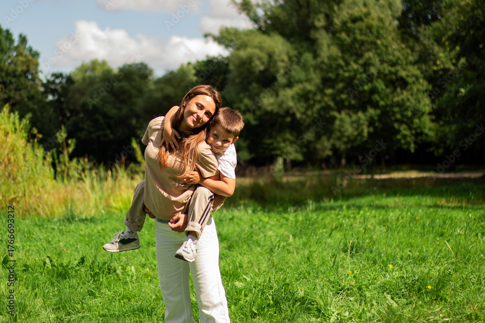 Fototapeta premium Six years old boy and his mom twirl together and laughing. Heartwarming display of mother son fun and connection.