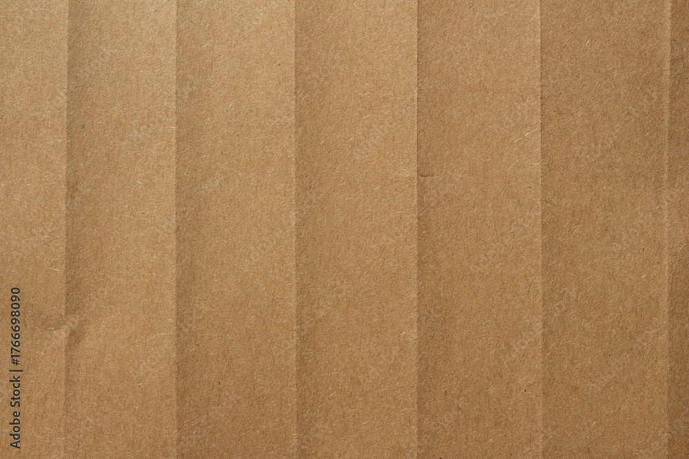 Fototapeta premium Brown crumpled kraft paper texture with deep folds and creases