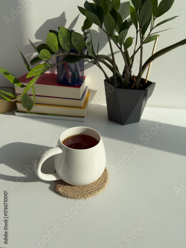 Cozy Workspace with Cup of Tea and Indoor Plant – Minimal Home Office with Green Plant and Warm Light