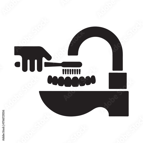 Hand cleaning gas stove burners with a brush under a faucet