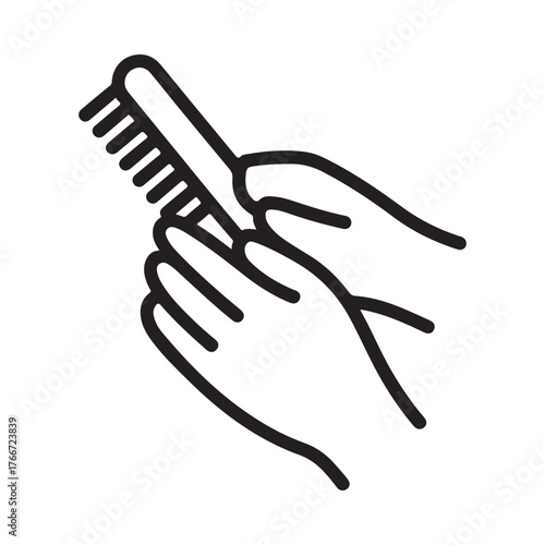 Hands holding a brush for cleaning or grooming
