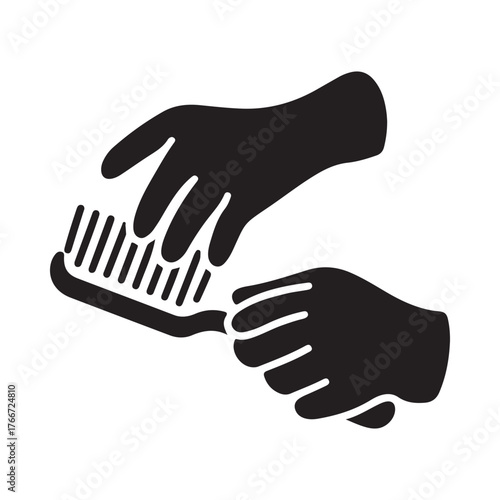 Black silhouette of hands wearing gloves cleaning with a brush