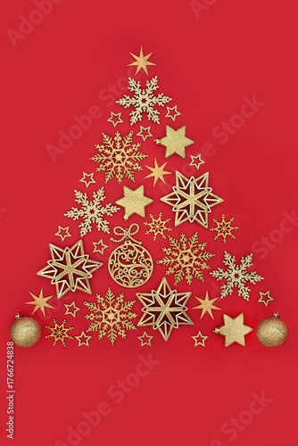 Christmas tree concept shape with gold star snowflake, sphere decorations on red background. Icon symbol for the Xmas holiday season. Greeting card, label, gift tag. 