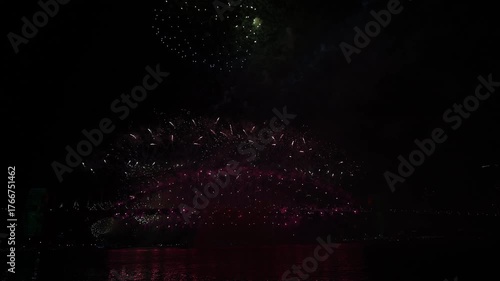 Spectecular new years eve fireworks at Sydney Harbour Bridge 2024 2025 with colorful pyrotechnics, illuminated Opera house and Skyline, view from blues point across the bay, New South Wales, Australia