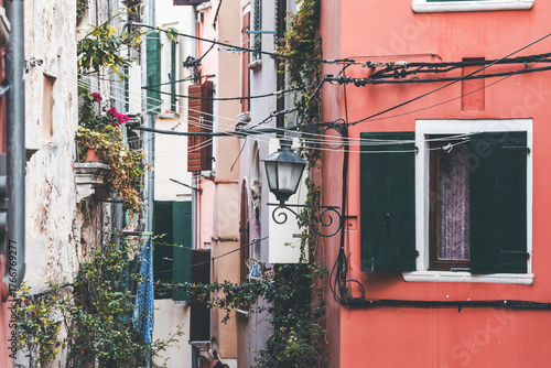 colorful windows and walls with lamps and flowers in rovinj