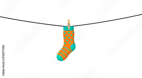 Single, colorful orange and teal striped sock with polka dots hangs from clothesline by wooden clothespin, isolated on, representing laundry or fashion