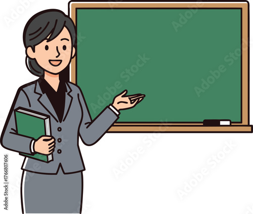 Professional female teacher in a grey suit gesturing towards a blank green chalkboard.