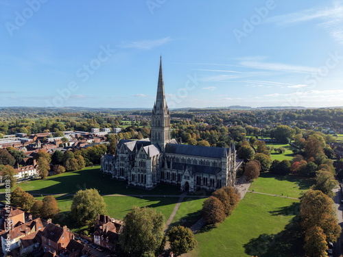 Aerial view of Salisbury Cathedral showing spire, roof, and surrounding landscape on a clear day. Perfect for travel, architecture, and tourism projects.