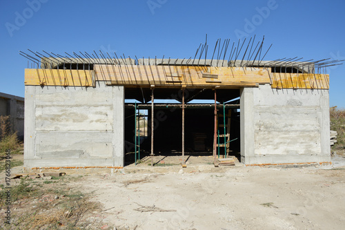 construction of a new garage. the building is missing a gate and a roof. construction industry and industry. a place to store cars