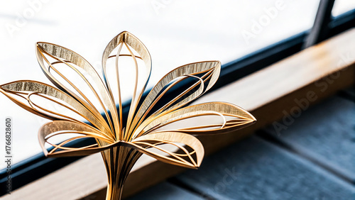 Close up of a golden lotus flower ornament with intricate details against a blurred background