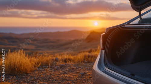 Minimalist travel scene with a clean, open car trunk at sunset, dry earth stretching endlessly, golden rays pouring into the empty interior, atmosphere filled with serene stillness