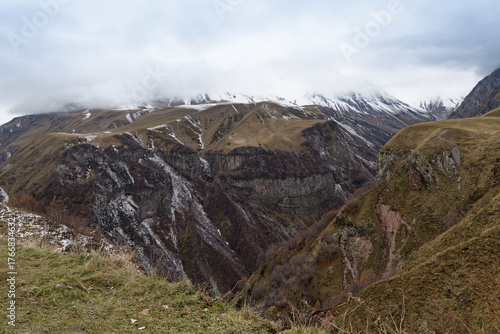 Mount Kazbek is a dormant stratovolcano in the Greater Caucasus mountains in Georgia  with snow on the top and a cloudy sky.