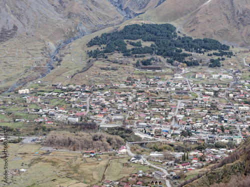 A beautiful scenery of Stepantsminda or Kazbegi town near Mount Kazbek in Georgia. The town is surrounded by mountains and has a peaceful, serene atmosphere.