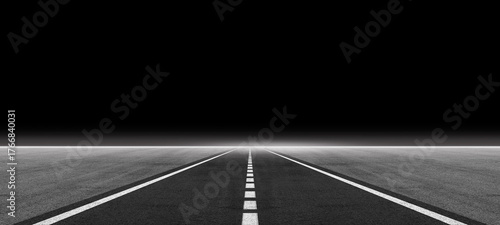 Empty asphalt highway or airport runway with white dividing line and fog on a dark night background. Abstract smoke scene for Halloween, spooky atmosphere, product display, or futuristic road design.