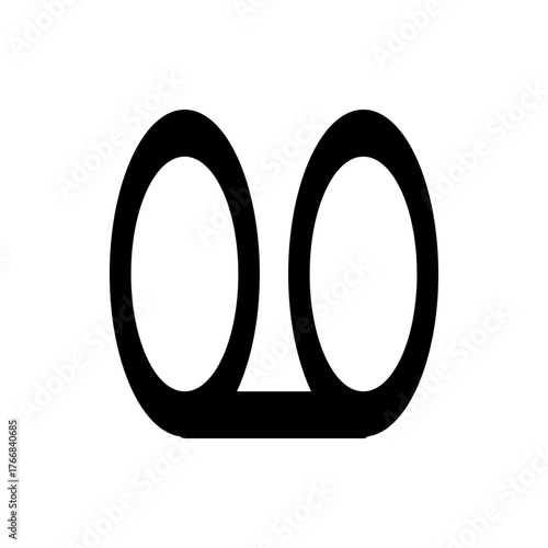 Black graphic of a cassette tape with two circular reels connected by a horizontal line in the center