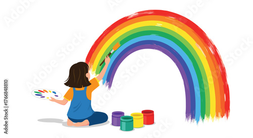 A young girl sits on the floor and paints a vibrant, colorful rainbow with a brush, using a palette and paint pots.