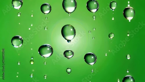 Refreshing green background video with glistening water droplets and light effect, perfect for your design