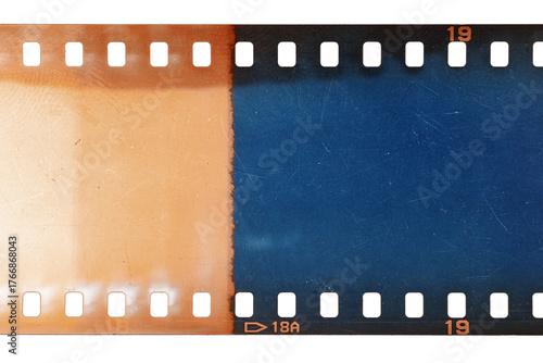 Dusty and grungy 35mm film texture or surface. Perforated scratched camera film isolated on white background.