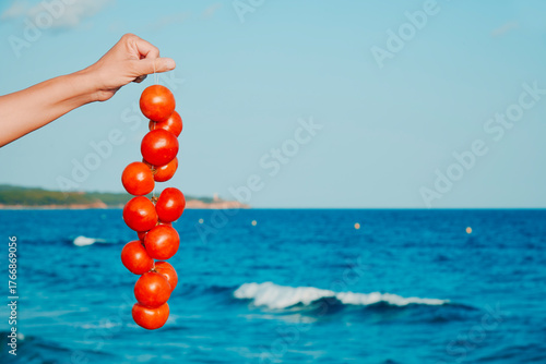 Fototapeta Naklejka Na Ścianę i Meble -  Spanish tomates de colgar over turquoise waves