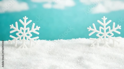 Delicate Snowflakes on a Soft Blanket of Snow Under a Bright Blue Sky with Fluffy Clouds in a Winter Wonderland Scene