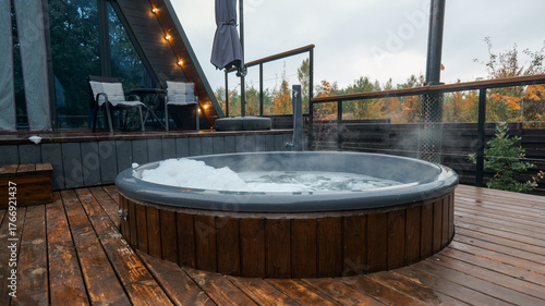 Outdoor hot tub on a wooden deck with a view of the forest