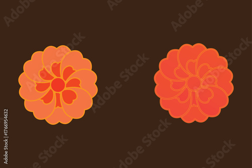 Two orange floral patterned cookies on a dark background