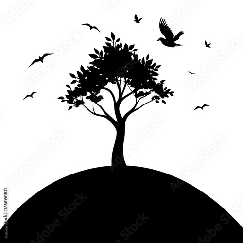 Silhouette of a solitary tree on a hill with birds flying in the sky