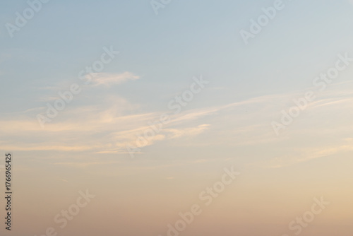 Serene sunset sky with soft pastel clouds and gentle horizon