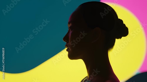 Profile of a Woman's Face in Dramatic Silhouette Against Abstract Colorful Background