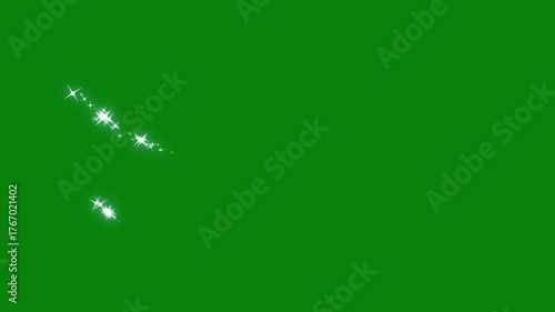 Glittering particle trails for video transition or wipe effect. star explosion, twinkle magic, magic FX, glitter particles light trail on a green screen background, alpha channel loop 4k animation