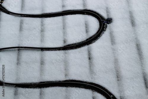 heat cable element install for de-icing roof in winter with fresh snow blank empty background with space for copy. heating cables and home improvement. cold climate design element.
