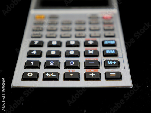 A handheld electronic vintage calculator with an LCD display and 42 keys. It was manufactured in Japan and was a popular model among students and technicians in the 1980s.