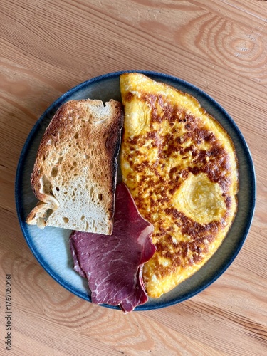 Homemade Stuffed omelette with bacon and sourdough bread slice